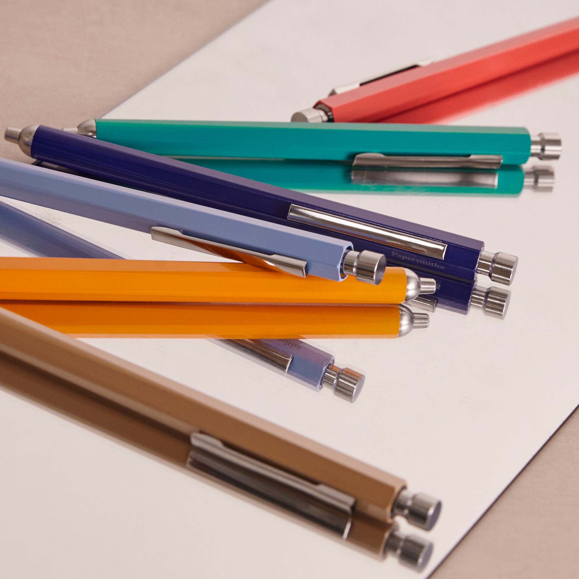Set of multicolored pens on a white surface