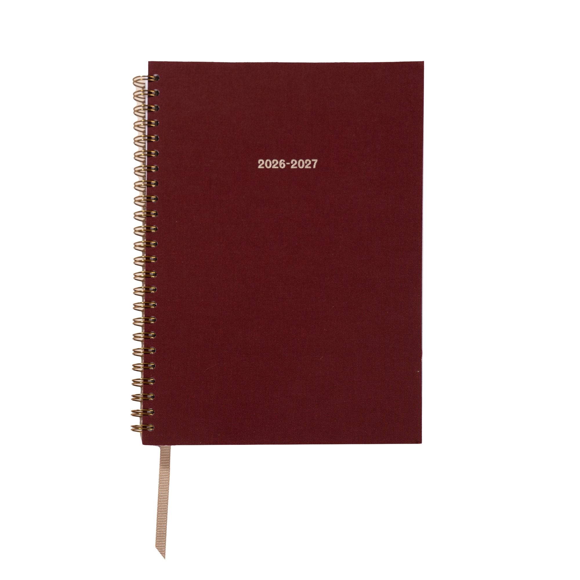 Maroon planner with gold spiral binding on a white background