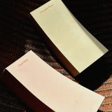 Two beige to do pads with 'Guest Room' text on a textured surface