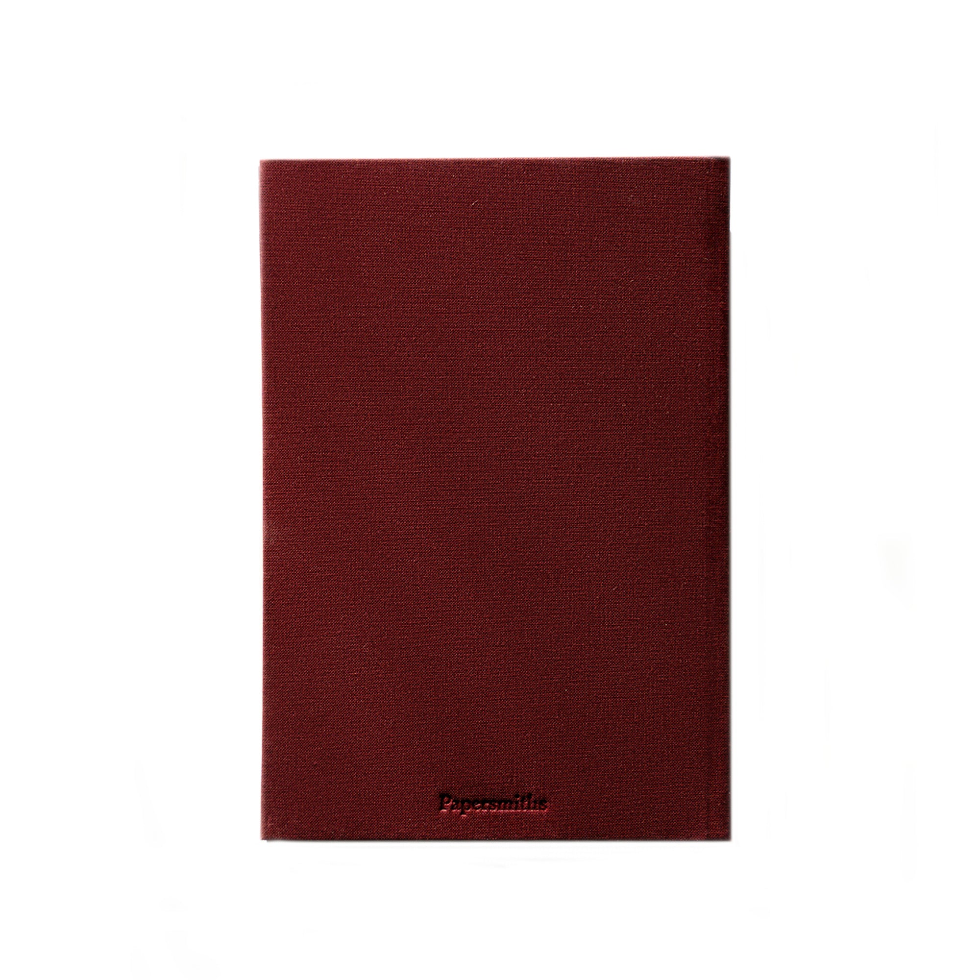 A dark burgundy textured linen notebook cover with the brand name Papersmiths embossed at the bottom, shown against a plain white background.